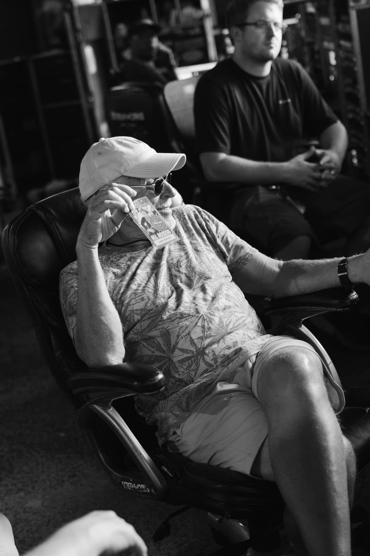 Jimmy Buffett backstage on tour, with Jeremy Clevenger behind him